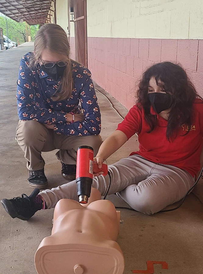 Reese demonstrating a heat gun technique during a workshop